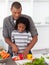 Attentive father helping his son cut vegetables