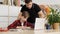 Attentive father stands near the table and explains the task to his son before writing to the textbook slow motion