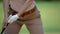 Attentive female golfer focusing on shot, standing address setup position, sport