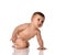 Attentive infant baby toddler in diaper stands on all fours touching his leg looking up trying to stand up