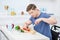 Attentive male person cutting vegetables