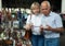 Attentive mature spouses buying retro handicrafts on flea market