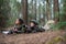 Attentive mother and son taking pictures in forest