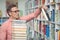 Attentive school teacher holding book in library