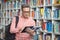 Attentive school teacher using digital tablet in library