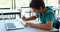 Attentive schoolboy studying in classroom