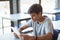 Attentive schoolboy using digital tablet in classroom