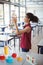 Attentive schoolgirl experimenting molecule model in laboratory