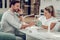 Attentive short-haired man having pleasant conversation during manicure session