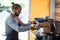 Attentive waiter making cup of coffee