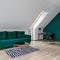 Attic living room with green sofa