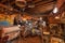 Attic of old antique store with many vintage utensil, decor, wooden furniture, retro bicycle and many details
