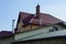 Attic of a private house with a brown tiled roof and chimneys