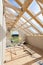 Attic room under construction with gypsum plaster boards. Roofing Construction Indoor. Wooden Roof Frame House Construction