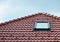 Attic skylight window on red ceramic tiles house roof outdoor. Attic Skylights Home Design Ideas Exterior.