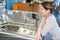 Attractive adult woman choosing bathroom furniture in shop