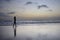 Attractive african american black woman walking on sunset beach enjoying water and sand relaxed