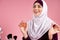 Attractive Arabian woman in hijab uses perfume