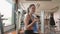 Attractive Asian girl drinking water from bottle in fitness sport gym. Close-up of young woman enjoying fresh water