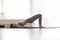 Attractive Asian indian woman practice yoga Half bridge pose to meditation in bedroom after wake up in the morning Feeling so