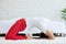 Attractive Asian woman practice yoga Light thunderbolt pose or Laghu Vajrasana pose to meditation in bedroom