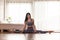 Attractive Asian woman practice yoga Side spilt pose to meditation in bedroom after wake up