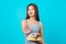 Attractive Asian young woman doing no action with donuts on isolated blue color background, weight loss and avoid junk food for