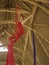 Attractive and athletic aerialist woman hanging from silk fabric doing aerial dancing workout training happy at beautiful hut in