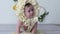 Attractive baby boy in headdress poses at camera on photoshoot