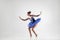 Attractive ballerina with bun collected hair wearing blue dress