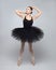 Attractive ballerina poses gracefully in the studio on a white background