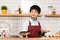 Attractive barista holding plates with delicious pastry in coffee shop.