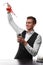 An attractive bartender at a bar counter doing a cocktail, a plate of lime isolated on a white background.