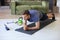 Attractive beared man doing plank exercise at home during quarantine. Fitness is the key to health