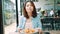 Attractive beautiful Asian woman food blogger using smartphone or camera photo and recording making food blog video.
