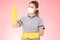 Attractive Beautiful Asian woman maid wearing face mask and gloves smile and pointinng sign for display product feeling so happine