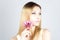 Attractive beautiful blonde with a pink flower. Woman with permanent makeup.