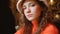 Attractive beautiful girl in a cafe looks cute. Young curly green-eyed woman in a stylish fluffy hat and orange sweater