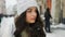Attractive beautiful lady walking over snowy city background
