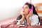 Attractive beautiful woman is listening music by using Bluetooth and connect to smartphone. Charming beautiful asian woman wears