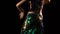 An attractive belly dancer shakes her hips in a shining oriental outfit amidst the raindrops. Brunette with long hair