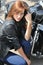 Attractive biker woman and her motorcycle