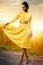 Attractive black girl wearing stylish yellow dress in vineyard.