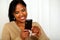Attractive black woman sending a text message
