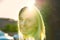 Attractive blond woman backlit by sun flare