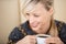 Attractive blond woman enjoying her cup of coffee