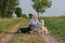 Attractive blond woman on a rural path with her three dogs