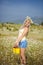 Attractive blonde in chamomile field. Young woman in wreath