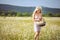 Attractive blonde in chamomile field. Young woman in wreath