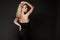 Attractive blonde fashionable girl in black dress posing isolated